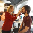 Latvian American Eye Center representative demonstrates the eye pressure assessment device
